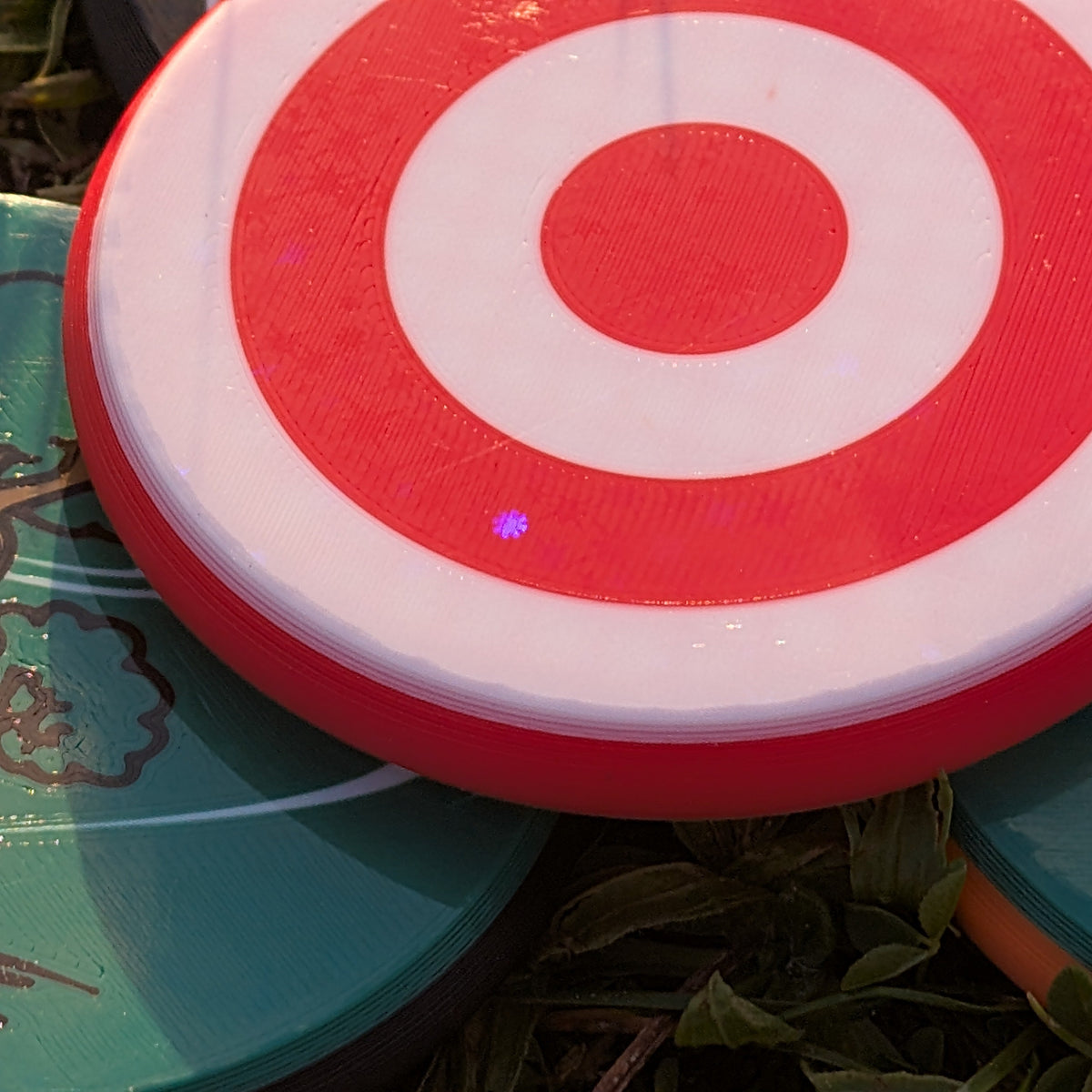 Red and white target-like object on a green surface with text